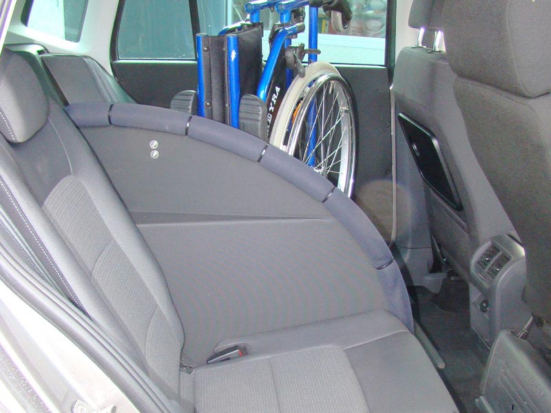 gefalteter Rollstuhl steht in der hinteren Sitzreihe eines PKW